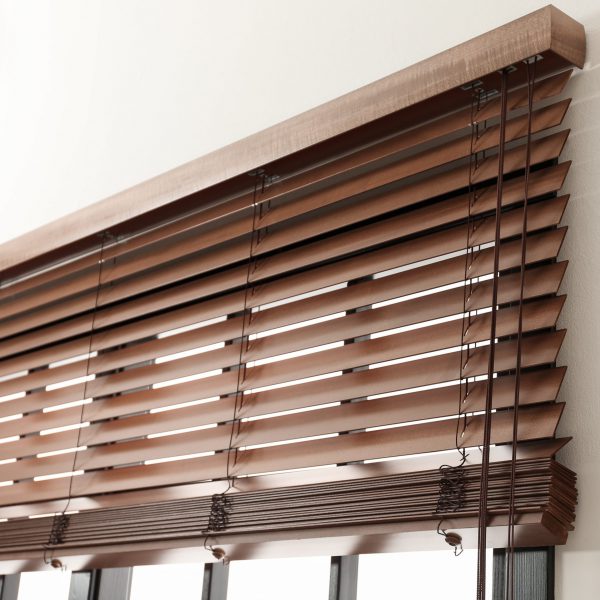 Modern window with stylish wooden blinds indoors